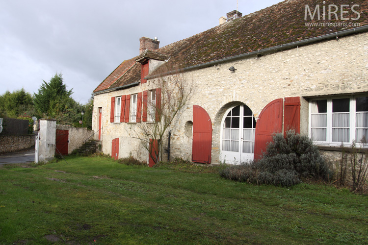 Farmhouse with large arched double doors. C0660