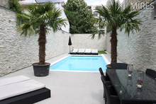 Outdoor swimming pool with palm trees. C0549