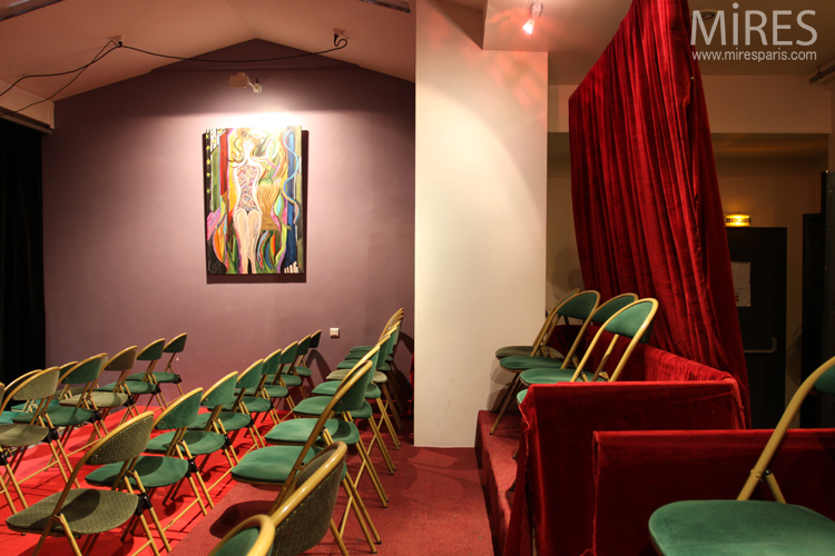 C0685 – Small hall and stage, red curtains, green chairs