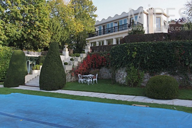 Aback, overview on the swimming pool in the middle of the shaped park. C0774