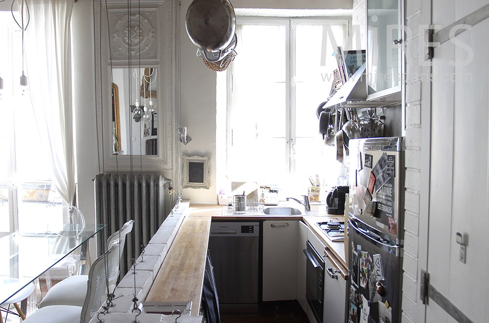 Narrow kitchen with bar. c1554