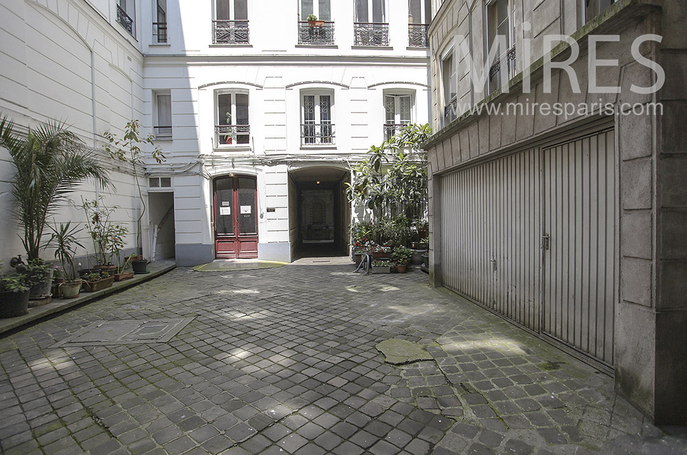 Paved courtyard with garage. C0101