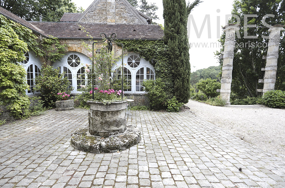 C1604 – Paved courtyard, flowery well