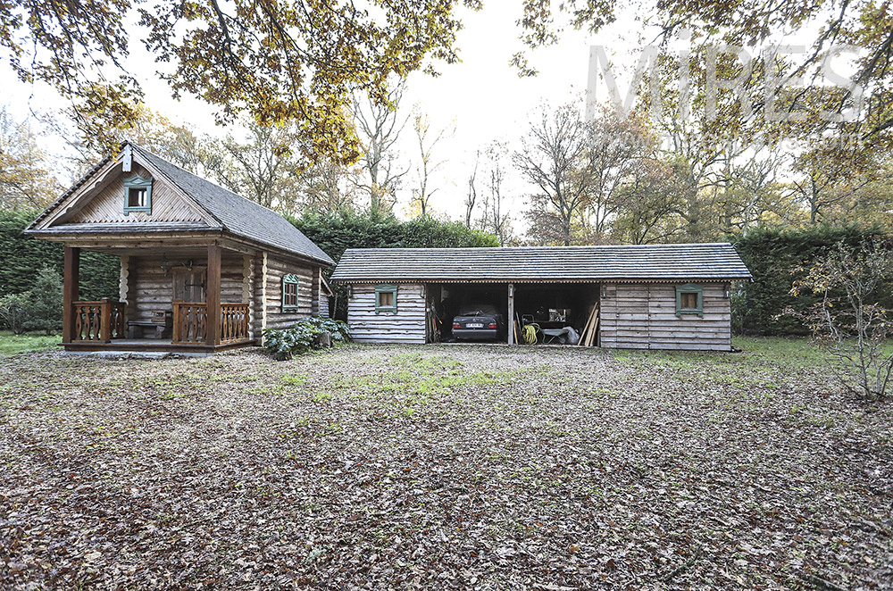 Garage and log cabin. c0224