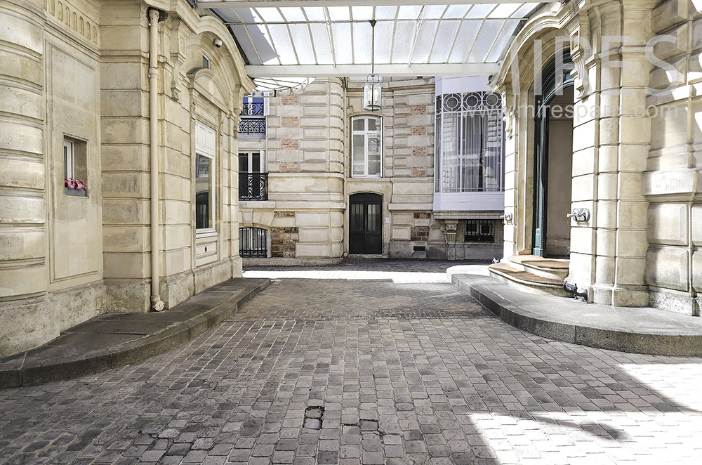 Paved courtyard of building. C1935