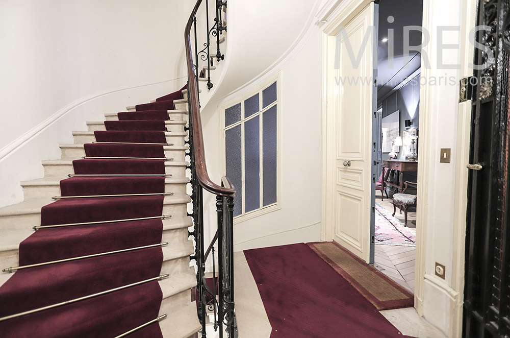 White staircase with red carpet. C1950