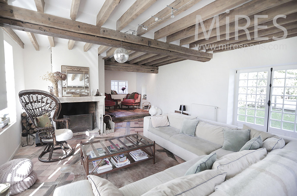 White living room, exposed beams. C1978